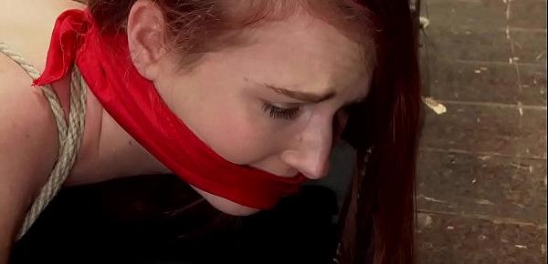  Gagged redhead on hogtie is suspended